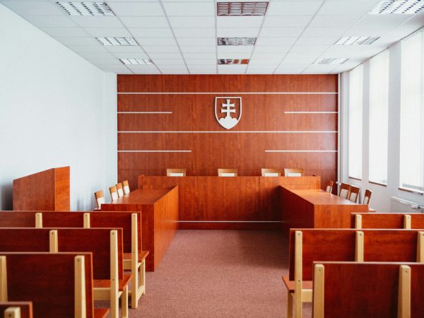 a room filled with wooden desks and chairs